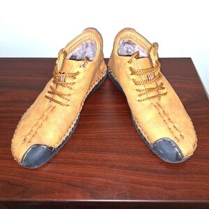 A pair of Fashion Sport moccasin booties with a furry insole.In a men's US 12.